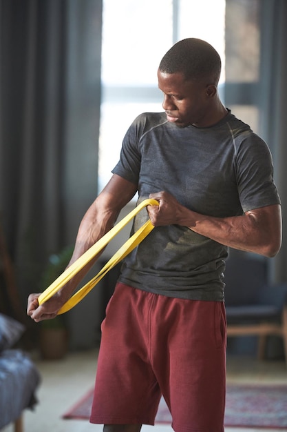 A person using resistance bands in a home gym setting, focusing on different muscle groups. The image should illustrate muscle-strengthening activities and their accessibility.