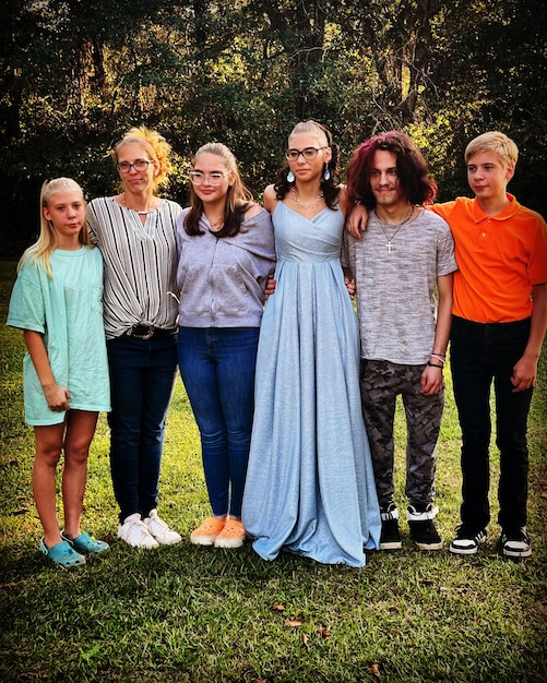 A diverse group of people of different ages and ethnicities standing in natural sunlight, highlighting the effect of varying skin pigmentation on vitamin D absorption. Sunlight should be a key element, but not overpowering so features can be seen clearly.