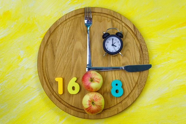 A visual representation of the 16/8 intermittent fasting method, showing a clock graphic with a highlighted 8-hour eating window and a 16-hour fasting window. The background includes healthy food options like fruits, vegetables, and lean protein sources.