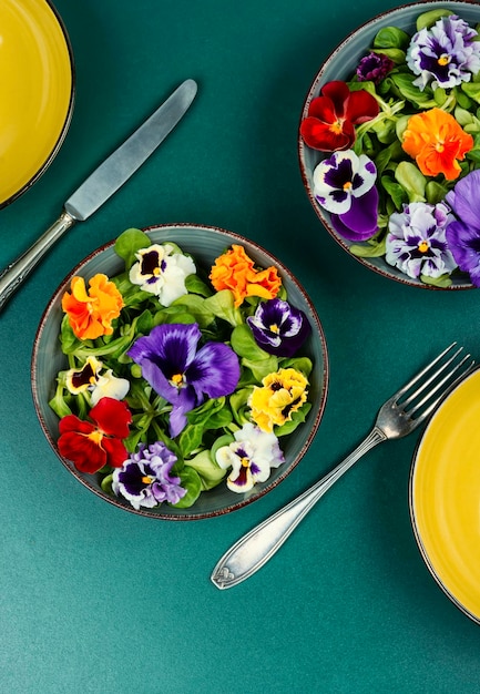 A table setting featuring a balanced vegan meal. The plate contains a colorful mix of stir-fried vegetables, brown rice, and grilled tofu. Utensils are neatly arranged, and a glass of fresh green juice sits beside the plate. The image conveys a sense of health and mindfulness.