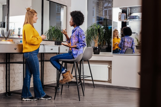 A co-working space located in a suburban setting, featuring modern design, collaborative workstations, and private offices. The scene should emphasize the blend of professional and community-oriented environments, catering to the needs of remote workers seeking a change from working at home.