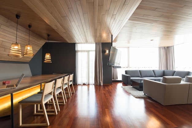 Interior of a brightly lit and spacious modular home with modern furniture, hardwood floors, and an open floor plan, highlighting the comfort and design possibilities of modular construction.