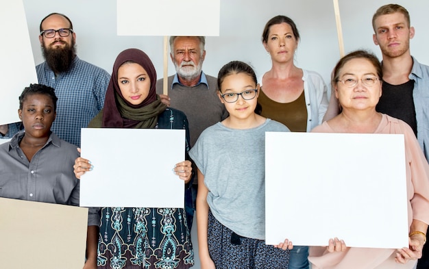 A diverse group of people standing together, holding signs advocating for immigrant rights and fair treatment. The scene captures the spirit of community and social justice within the immigration context.