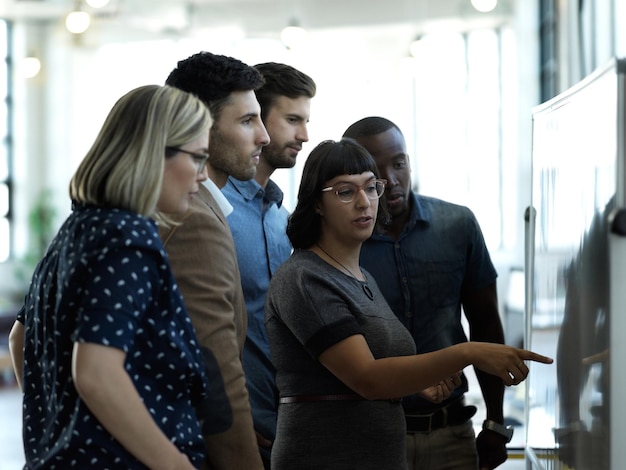 A group of diverse individuals participating in a cybersecurity awareness workshop, with a presenter pointing to a slide showing tips for online safety, such as strong passwords and avoiding suspicious links.