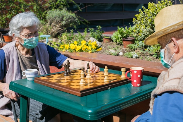 A group of senior citizens engaging in various activities, such as gardening, playing chess, and volunteering, symbolizing the aging population trend and its impact on society.