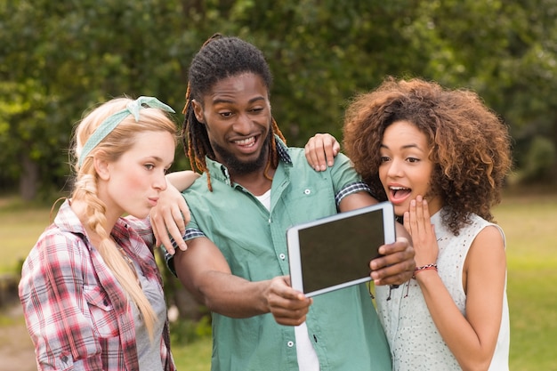 A picture of a diverse group of people in a rural community using laptops and tablets, connected to a 5G network. The image should convey the idea of empowerment and opportunity through technology.