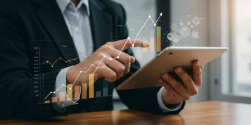 Person viewing financial growth charts on a tablet, symbolizing the positive impact of 2026 unemployment benefits.